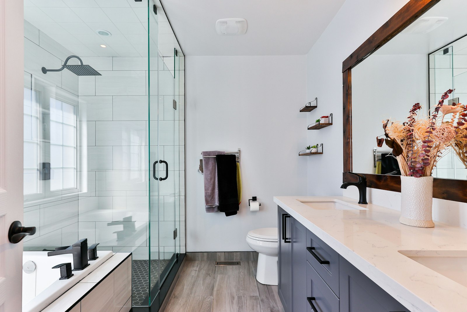 Renovated bathroom with a glass shower, vanity and wall-hung fixtures